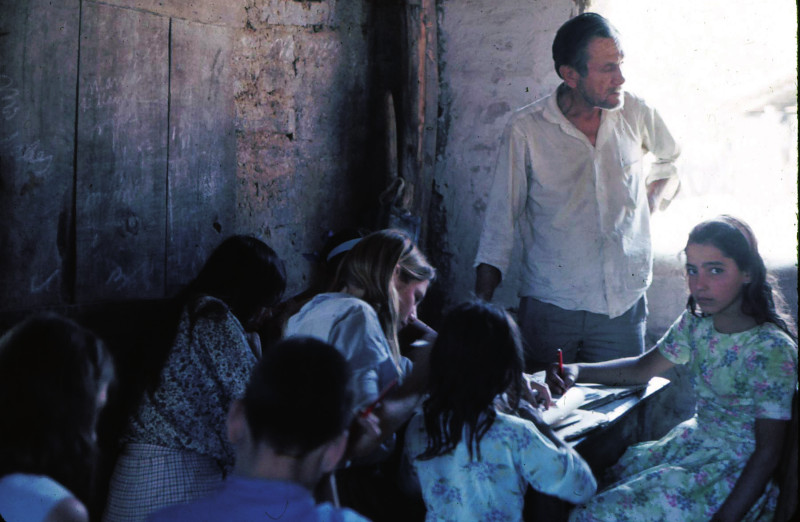 Students study in a one-room classroom.