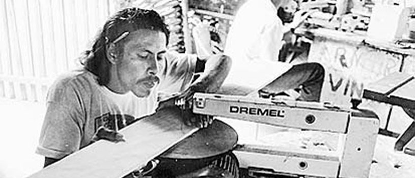 A disabled man using a machine tool.