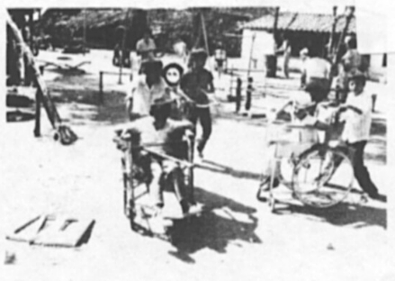 Because the playground attracts both able-bodied and disabled children, they learn to play together. Here able-bodied children race with disabled children in their wheelchairs.