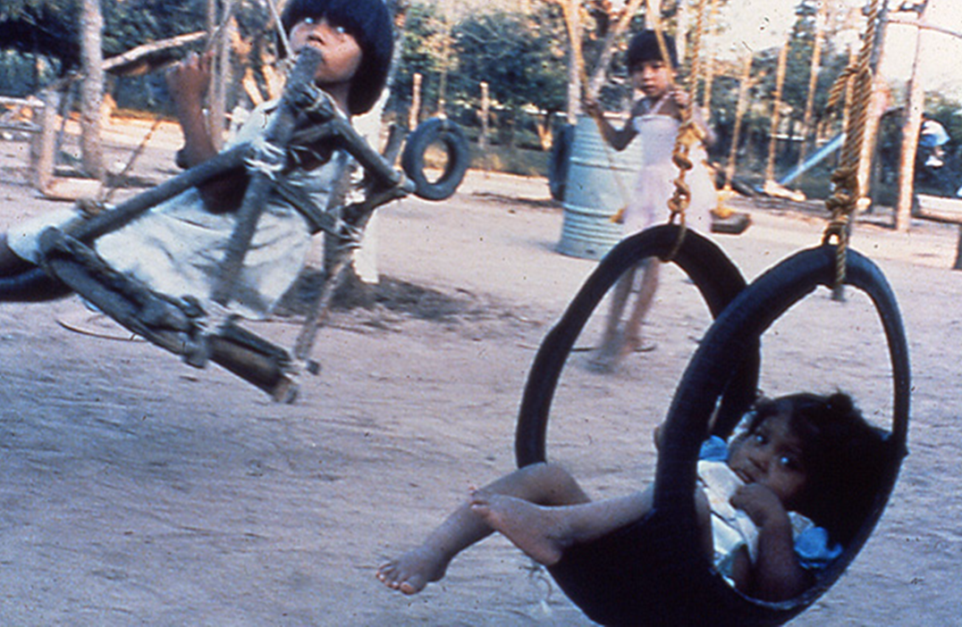 The swing on the right, made of an old car tire turned inside out, is especially good for spastic children because it bends their backs and shoulders forward.