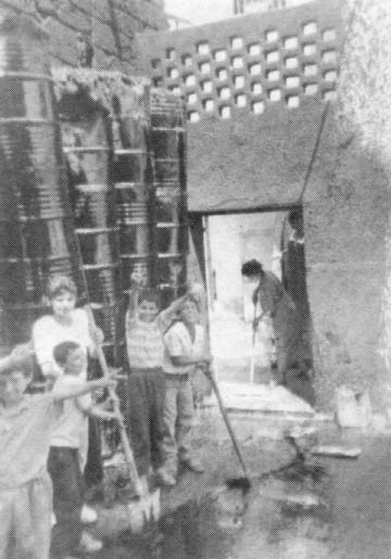 Palestinian children in front of sealed house.