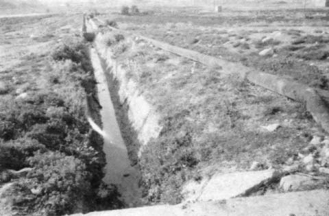 Two water lines in the Jordan Valley, West Bank. The enclosed pipe supplies drinking water for Jewish settlers, the open ditch for Palestinians.