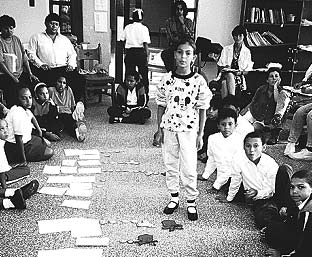 School children diagnose the problems affecting their health, while adult participants watch.