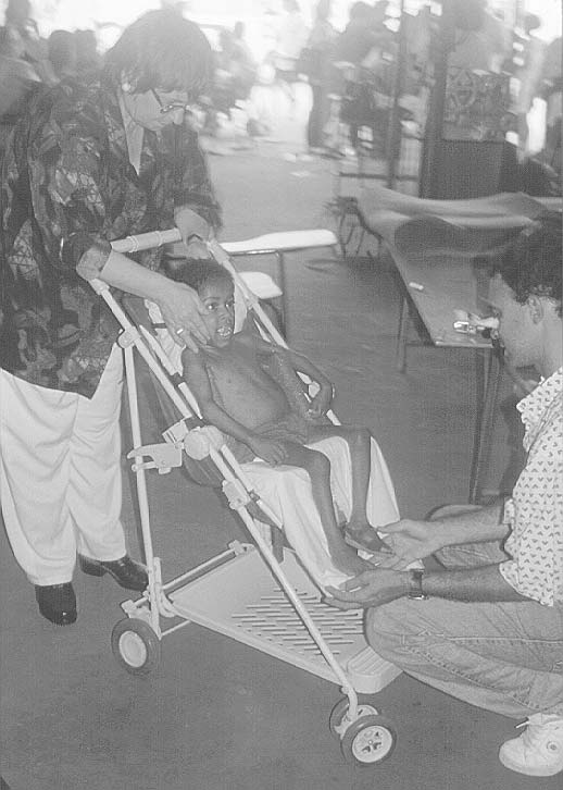 Course participants improvised a seat insert to help this disabled child sit in a better position in his stroller.