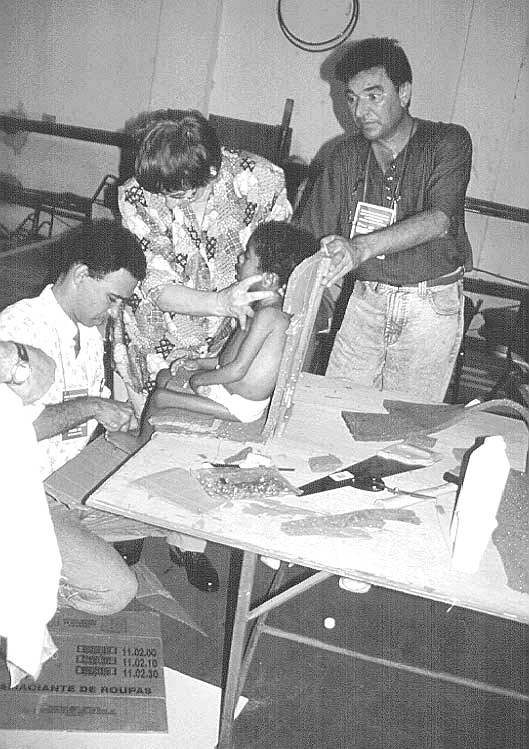 A group of participants used metal rods covered with cardboard to make a seat insert for a multiply disabled child from the hostel.