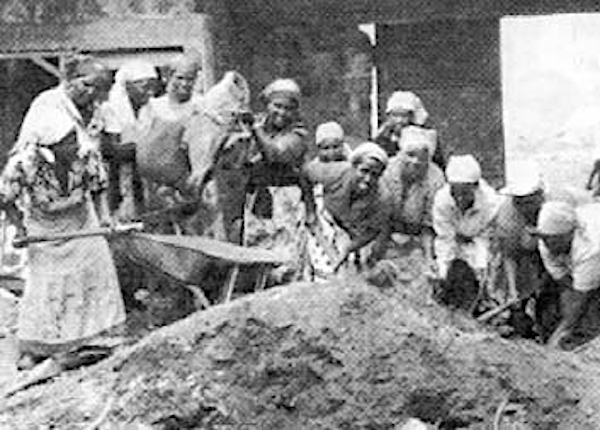 Mothers and grandmothers work together to build a could feed their children better and spend more time cooperative bakery. Here they make mud bricks of earth mixed with straw.