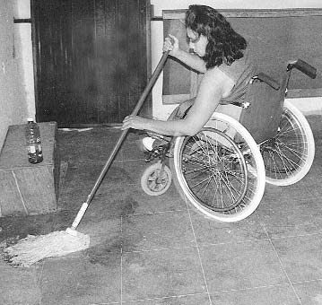 Cecilia, who is now married and runs her own household, helps to clean up PROJIMO's consultation room.