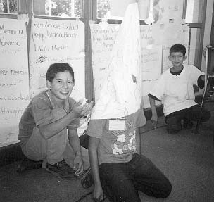 The children explored how to help one another in different disasters. Here, in a role play, one child acts the part of a volcano, which trembles and rumbles and then errupts. (The erruption occurs when the boy squatting behind the volcano throws handfuls of little balls of paper into the air.)