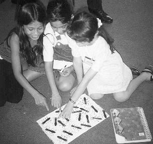 The children’s research disclosed that in some towns 50% of asthma cases are caused by cockroaches! Here they put toy "cucarachas" behind a wall hanging, under which—in a role play—they will find and remove them from a home (along with cats, chickens, feather pillows and other allergens).