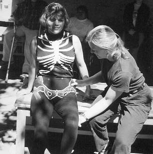 To help people learn the positions of the bones and the importance of obtaining a good (usually 90 degree) angle of the hips, Jean Anne demons-trates with Lupita, who wore a skeleton costume.