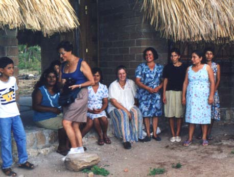 The Ashoka team visits with women at the MazunteCooperative Peanut Butter Factory. The thatch roof covers the arched ceilings of buildings made of strong, water-resistant compressed earth.