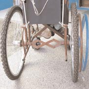 Figure 2 - This innovative wheelchair has a folding axle to transfer power from one hand rim to the far side.