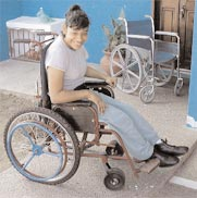 Figure 3 - A young lady with hemiplegic cerebral palsy smiles at her new mode of transportation.