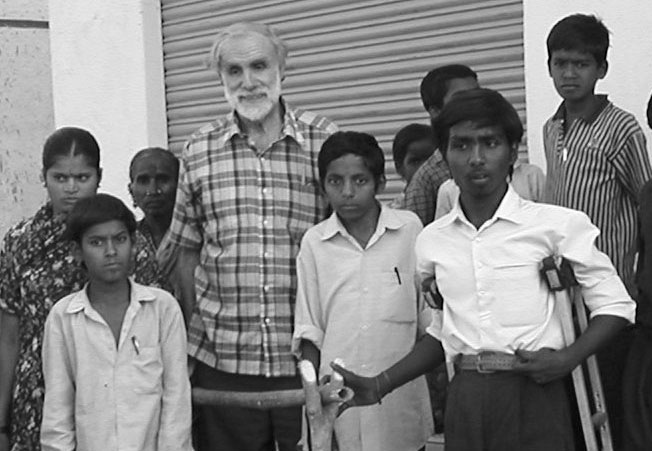 David Werner with Aruna Sangam disabled youths, by the parallel bars at their Neighbor-hood House.