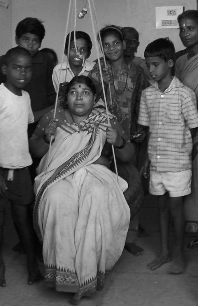 Sangam members demonstrate the tire swing.