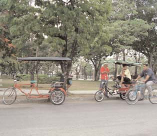 Bici-taxis (bicycle rickshaws) in Bayamo, the capital of Granma Province. Because of the shortage of gasoline due to the US embargo, Cuba imported 1 million bicycles from China, and now also produces its own. For every motorized taxi in Bayamo there are at least 50 bici-taxis.