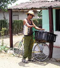 This young man, who has congenital deformities of both upper limbs and one leg, works delivering cooked meals every day to more than 20 disabled persons who are not able to come to the comedor.