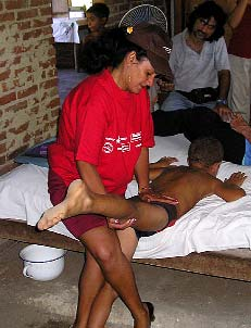To learn a good exercise for straightening Salvador’s hip contractures, Maritza first practiced on a willing boy.