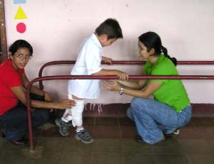 Evert walking with difficulty through the parallel bars.