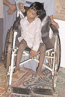 Jayaram sits awkwardly in a huge wheelchair.
