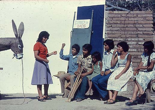 In the Sierra Madre of Mexico, village health workers found that malnutrition caused a high rate of death and disability in children. The primary cause was unfair distribution of land. Here health workers put on a skit to help the landless farmers join together and demand their constitutional land rights.