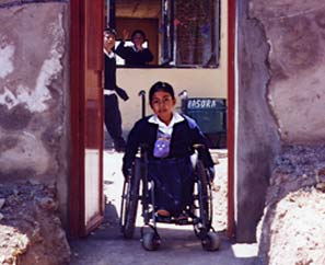The villagers helped knock a hole in the wall and put in a doorway. So now Magali can get into the school without having to go up the steps or a steep ramp.
