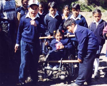 They even experimented with tying poles to her wheelchair so that more children could help transport her at the same time.