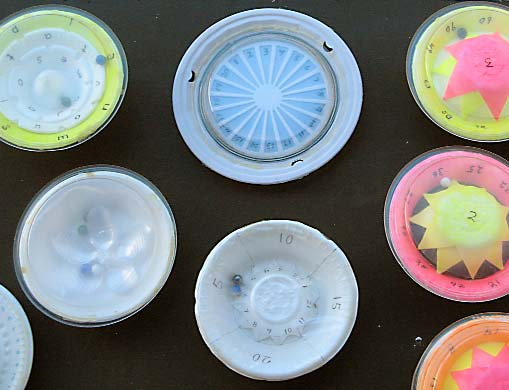 Many of the games, made by carefully cutting and gluing paper plates and bowls, work similar to a roulette wheel, using one or more marbles.