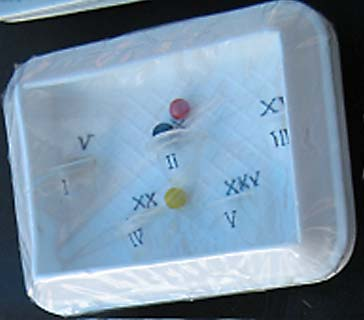 This game helps children learn how to read Roman numerals—by rolling marbles into the numbered pits.