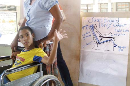 Juan David’s spasticity, from cerebral palsy, makes it very difficult for him to sit. The workshop participants designed for him a special seat that helps him sit much better.