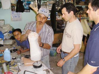 Marcelo making an artificial limb with guidance from visiting prosthetists Jon Batzdorff and Garret Hurly