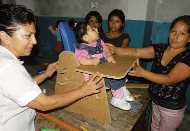 Here the group tests Leysi’s new cardboard seat for fit. It is vital to make sure that the seat fits properly before adding upholstery.