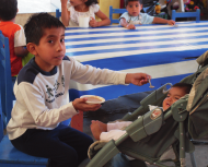 Patiently, Benigno helps feed one of the youngest children.