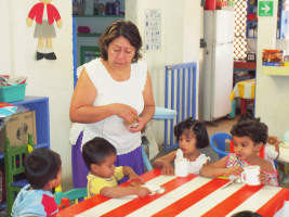 Doña Coco with some of the Children of the Moon at breakfast time. She guides them by her good example in an encouraging and kind-hearted way.