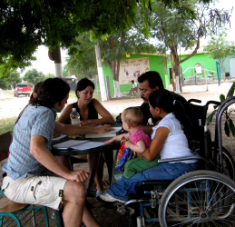Rigo and Virginia (with her son Jose Carlos) teaching Spanish to visiting volunteers at PROJIMO. The Spanish course was set up to generate income both for the program and the disabled instructors.