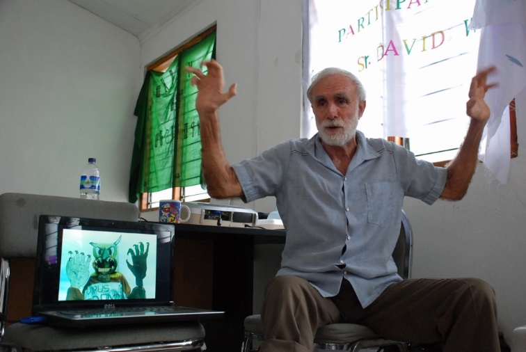 The low vaccination rate in Timor led to a recent epidemic of measles. Here David Werner shows the SHARE team a street theater skit in Nicargua, in which the "Measles Monster" attacks unvaccinated children.