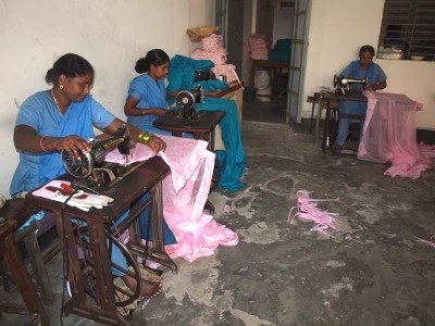 Women using sewing machines.