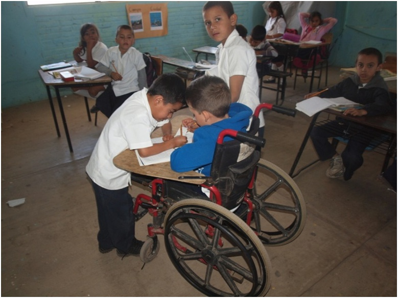 The teacher encourages and praises the children for the assistance and camaraderie they give to their new classmate.