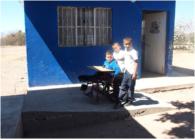 Two of his new buddies accompany Miguel Angel up the ramp to their classroom.