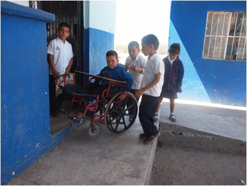 And here they help him over the door-stoop (which still doesn't have a ramp, but is not a major barrier).