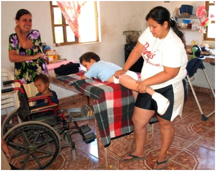 Now Yasmín teaches Miguel Angel's grandmother how to do the exercise.