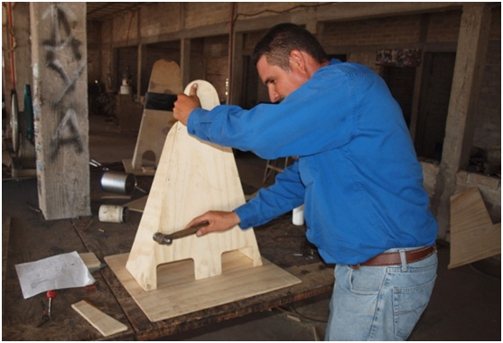 Here Polo, a volunteer with the program, makes a standing frame.