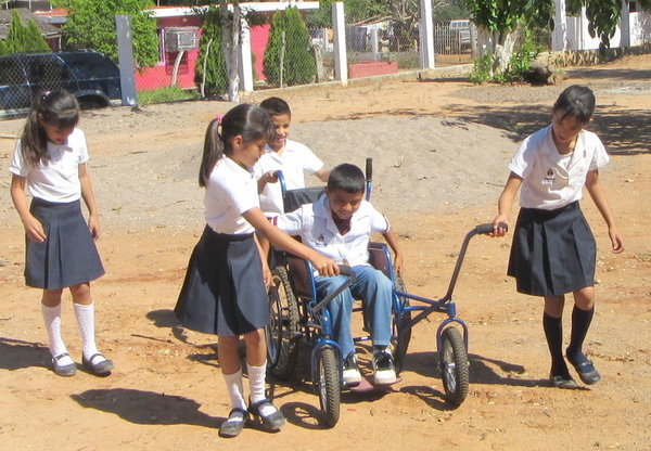 This boy helps propel the carriage using the hand-rims.