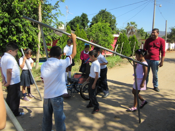 The children unload the welded pipes for the railings. (The pipes were delivered from Duranguito at the same time as Tonio's carriage.)