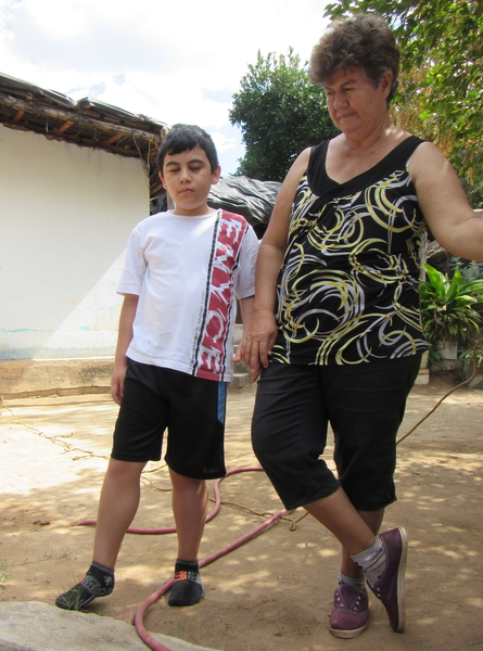 Tonio with his grandmother. His enlarged calf muscles are a key sign of Duchene's Muscular Dystrophy.