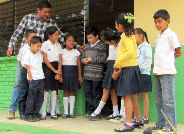 Teacher, Mario Alfonzo, encourages Tonio to take part in activities with the other children.