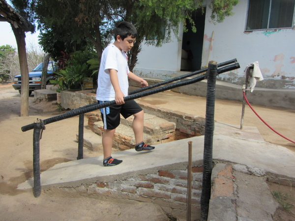 This ramp, built by Tonio's grandfather, gives the boy greater independence in getting up to his home. Tree saplings wrapped with plastic irrigation tubing prevents rotting.