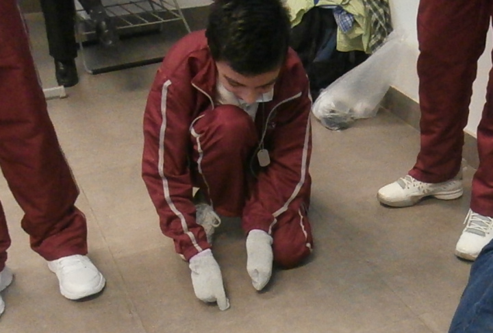 Trying to pick up coins from the floor with hands in stockings.