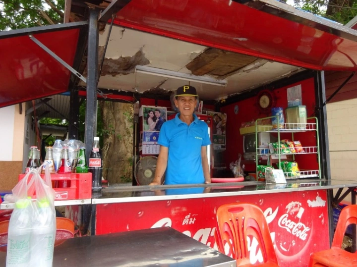 At his kiosk at the river crossing, a gay activist provides condoms and information to other MSM men.