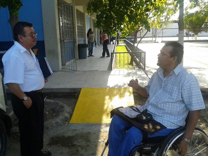 Here Rigo talks to a professor in front of one of the many ramps that the university constructed in response to the disabled students he mobilized for greater accessibility.